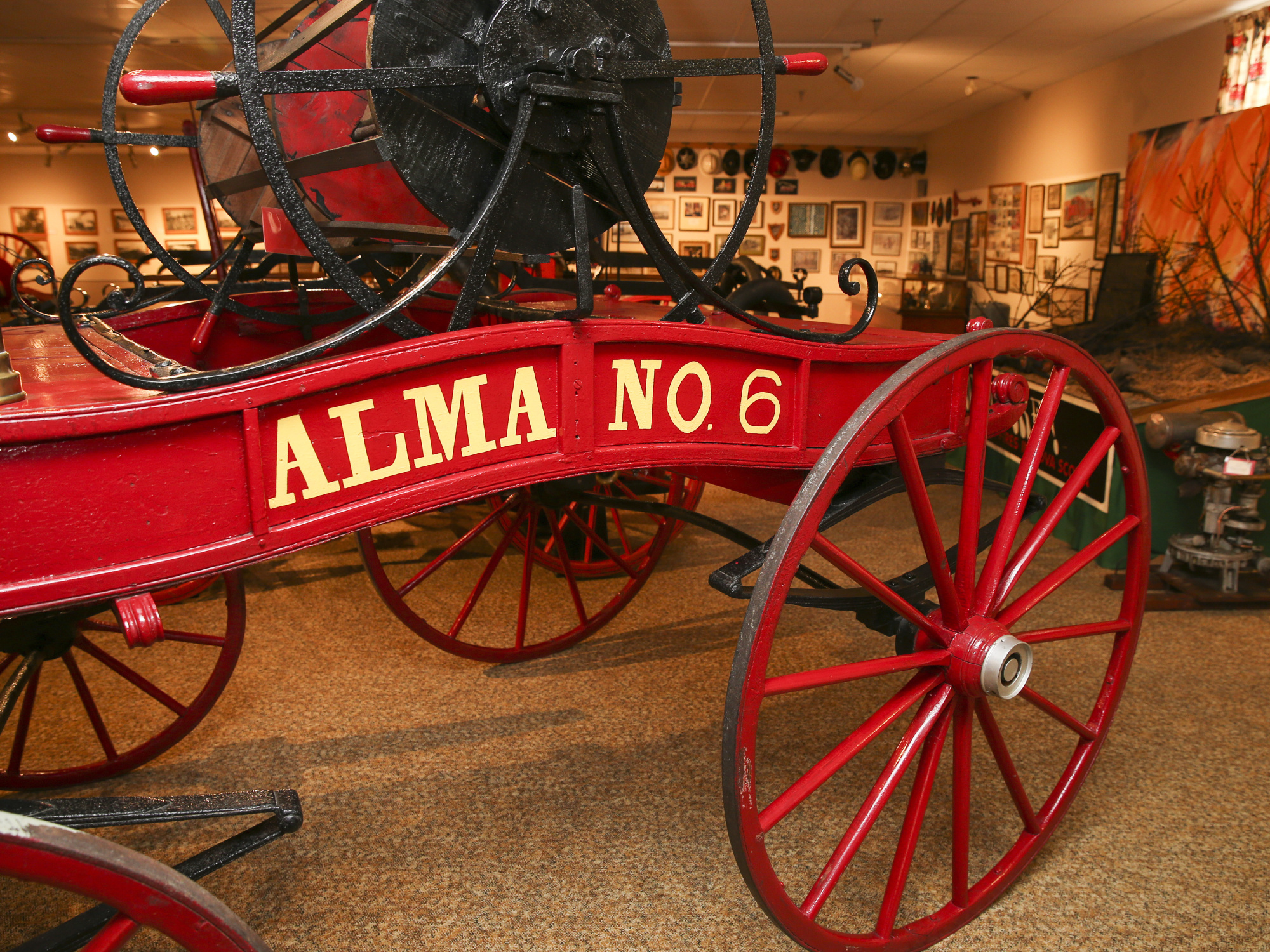 A close-up shot highlighting the details of a vintage fire truck with the name ALMA NO6 in gold lettering.